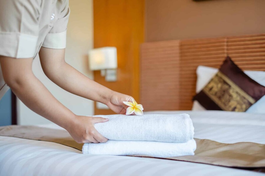 bigstock-A-Hotel-Maid-Stacked-Towels-On-415475518