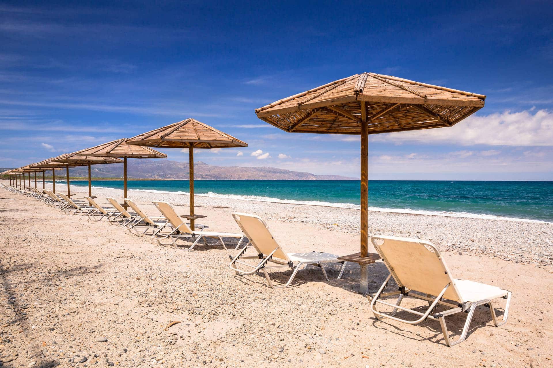 maleme-beach-bigstock-Tropical-parasols-at-Maleme-be-302140384 (1)